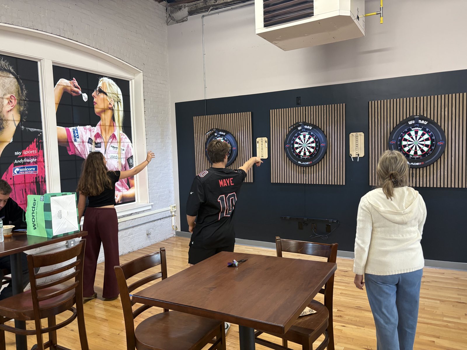 Friends throwing darts at Amazin Billiards in Peabody