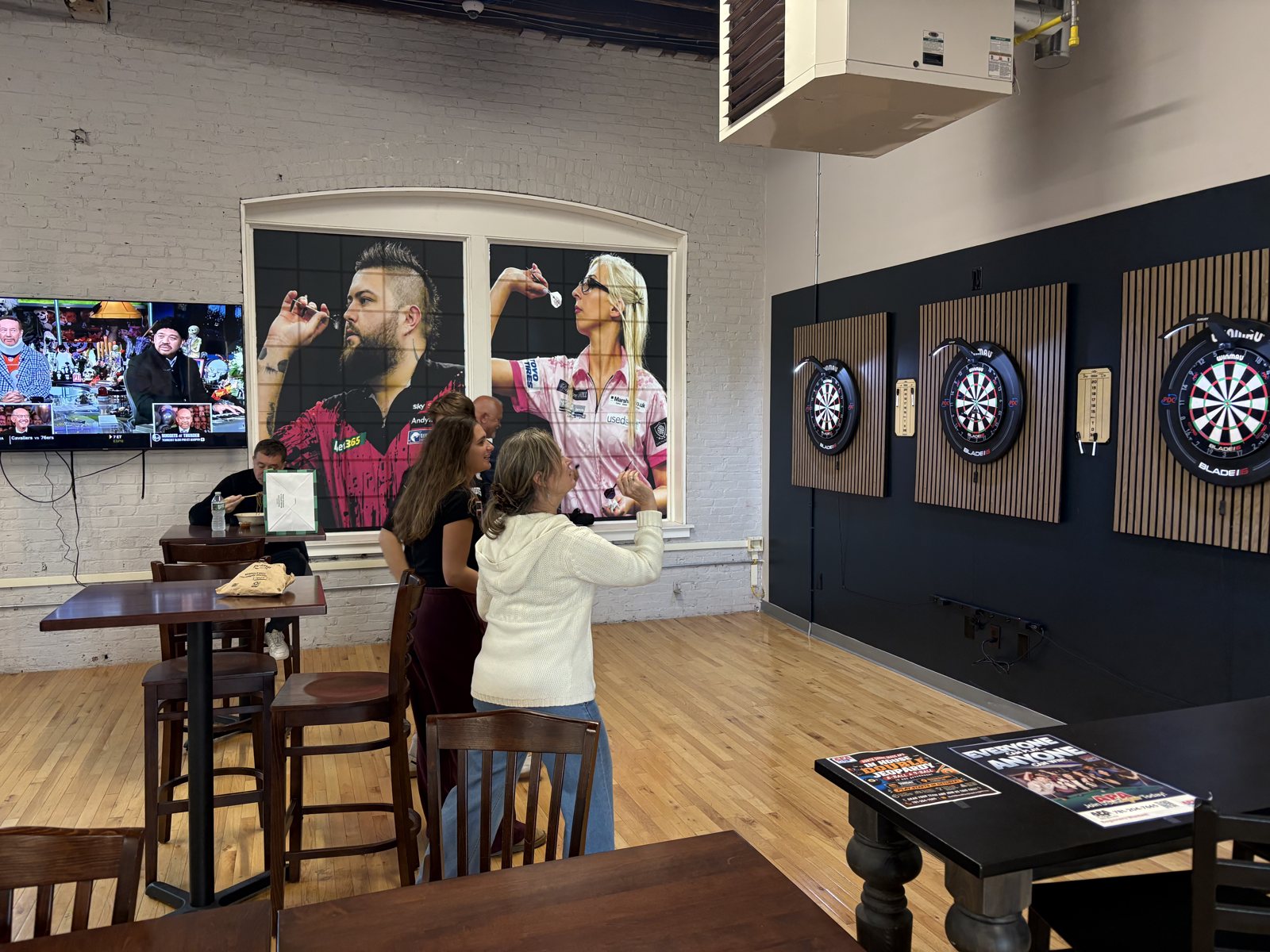 Players at the boards on a darts night