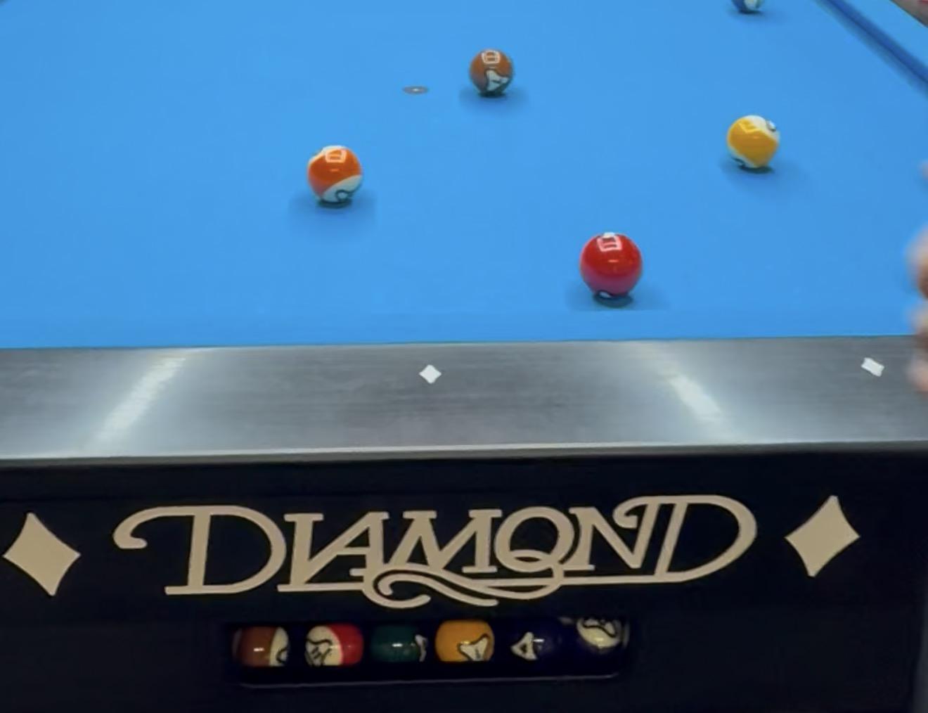 Diamond pool table with balls on blue felt